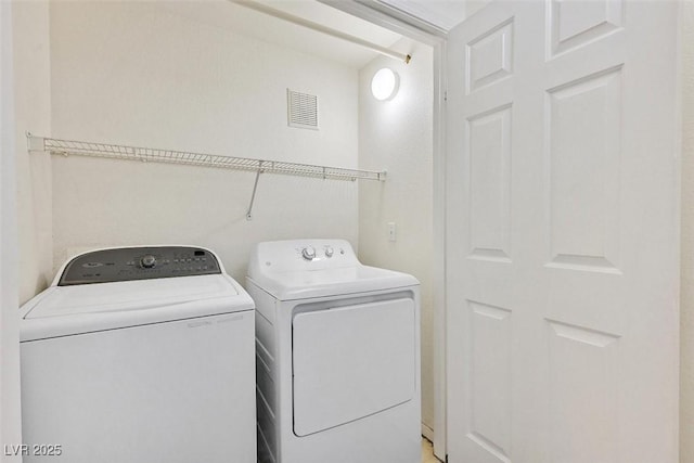 laundry room with washing machine and clothes dryer