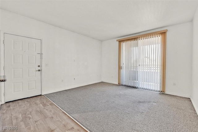 spare room with light hardwood / wood-style flooring