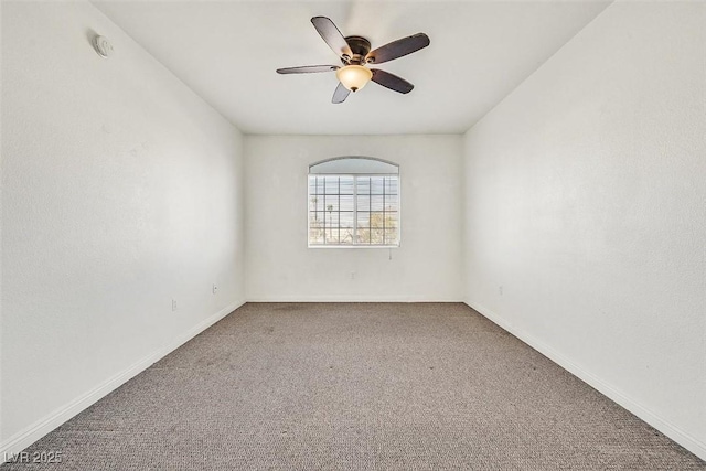 spare room featuring ceiling fan and carpet