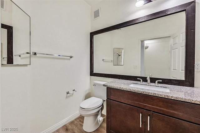 bathroom with vanity, hardwood / wood-style floors, and toilet