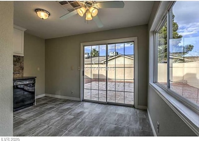 unfurnished living room with plenty of natural light and ceiling fan