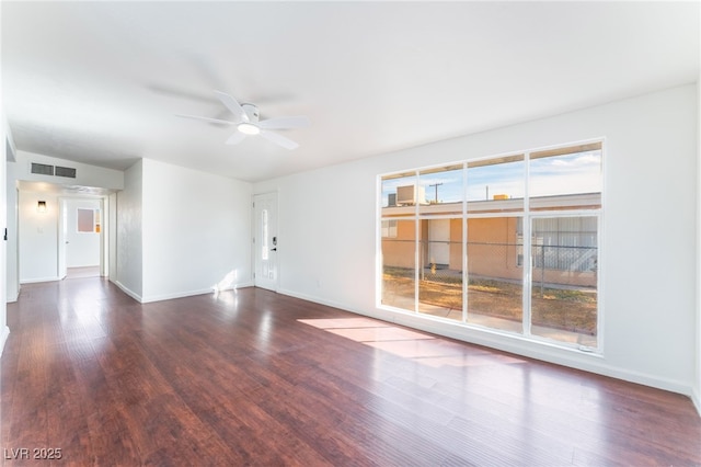 empty room with ceiling fan and dark hardwood / wood-style flooring