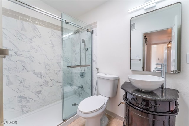 bathroom with vanity, a shower with door, and toilet