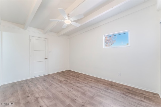 spare room featuring ceiling fan, lofted ceiling with beams, and light wood-type flooring