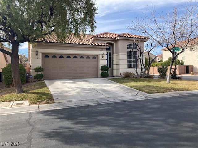 mediterranean / spanish-style house with a garage and a front yard