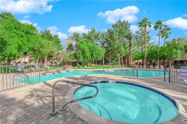 view of swimming pool featuring a community hot tub