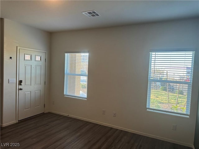 entryway featuring dark wood-style floors, plenty of natural light, visible vents, and baseboards