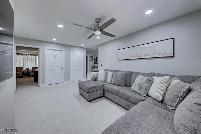 carpeted living room featuring ceiling fan