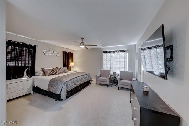 bedroom with ceiling fan and light colored carpet