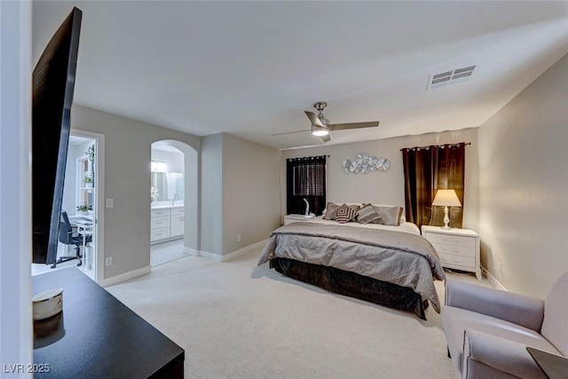 carpeted bedroom with ceiling fan and ensuite bathroom