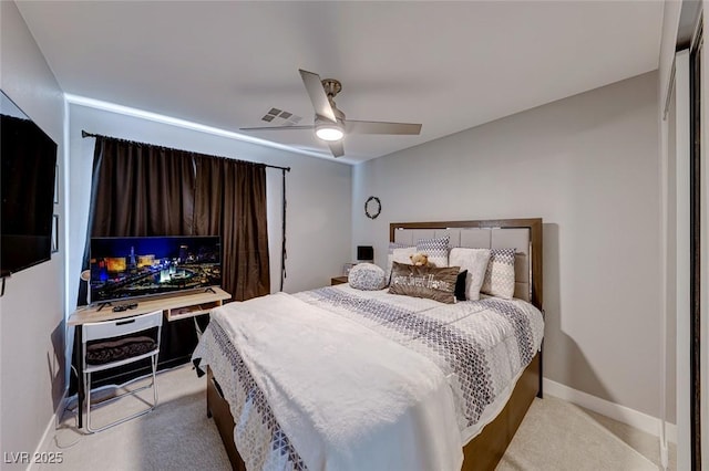 bedroom with ceiling fan and light colored carpet