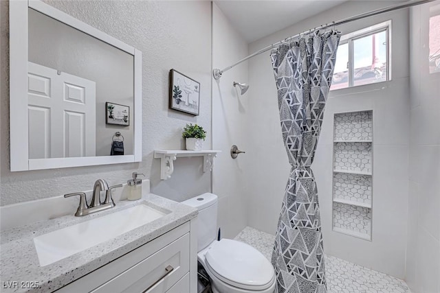 bathroom featuring vanity, toilet, and curtained shower