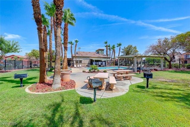 view of home's community with a pool, a patio, and a yard