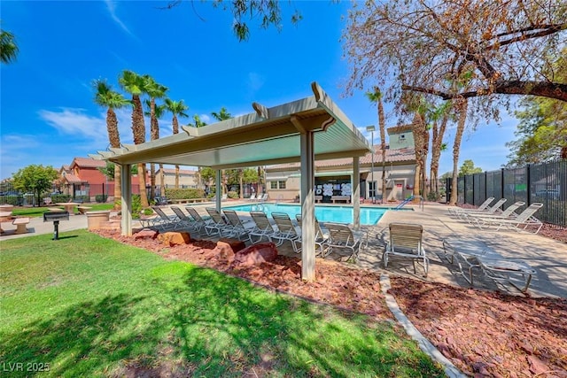 view of pool with a patio and a lawn