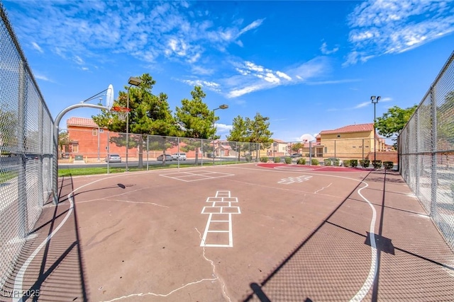 view of home's community featuring basketball hoop