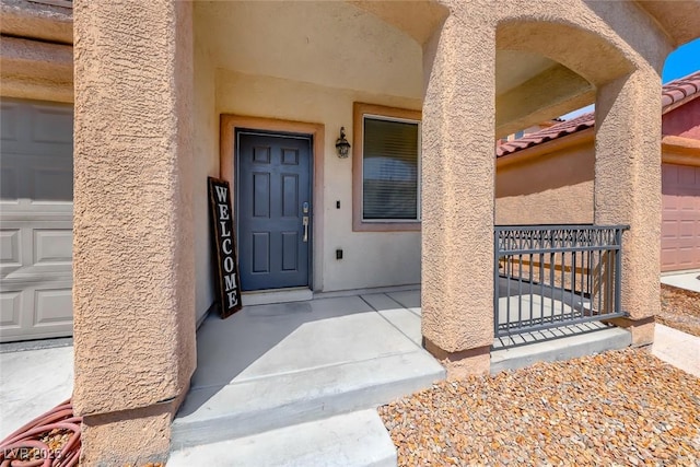 view of exterior entry with a garage