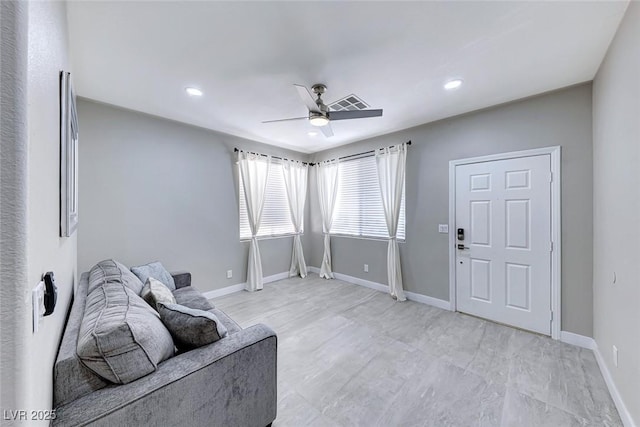 living area with ceiling fan