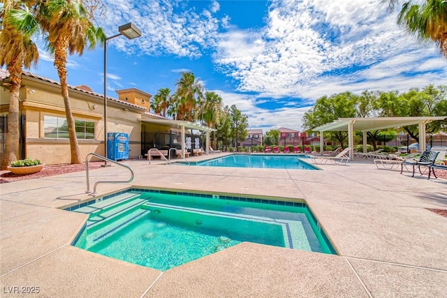 view of pool with a community hot tub and a patio area