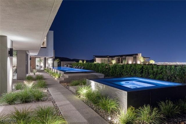 view of pool at night