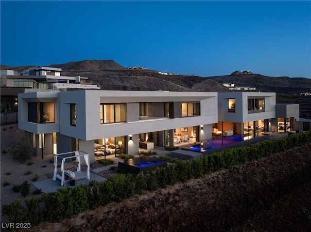 rear view of property featuring a mountain view and a patio