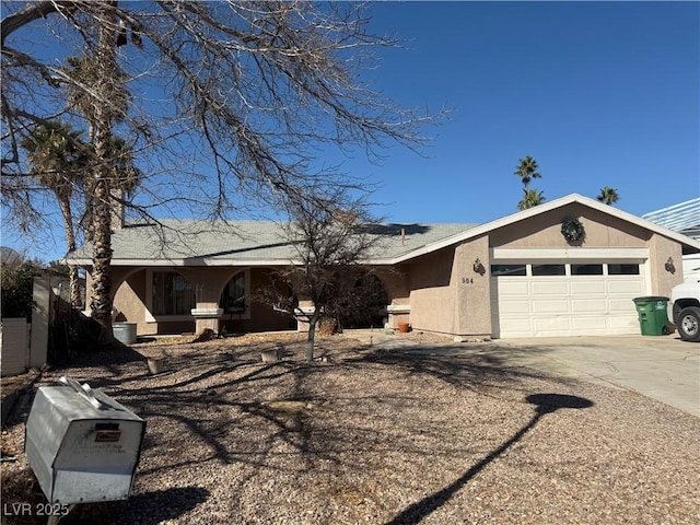 ranch-style home with stucco siding, driveway, and a garage