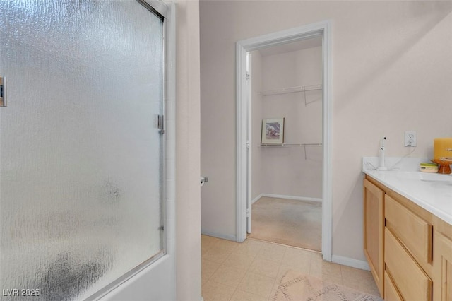 bathroom with an enclosed shower and vanity