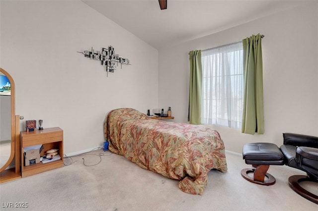 bedroom with ceiling fan, vaulted ceiling, and carpet