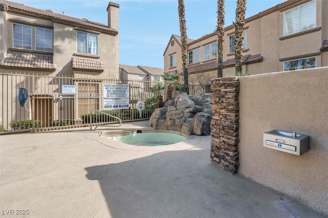 view of pool featuring a hot tub and a patio