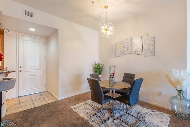 carpeted dining space featuring an inviting chandelier