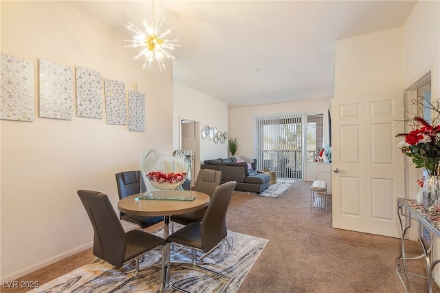 dining space featuring carpet and a chandelier