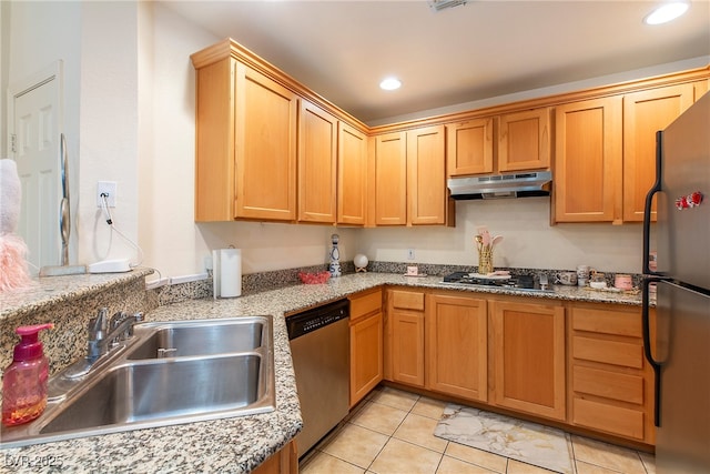 kitchen featuring light stone counters, stainless steel appliances, sink, and light tile patterned floors