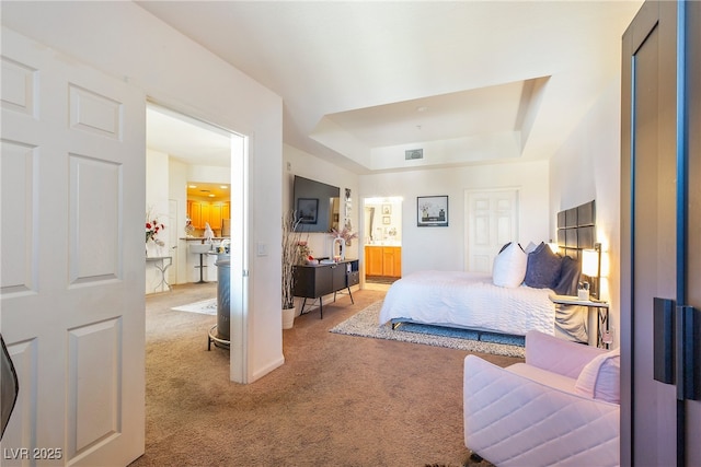 carpeted bedroom featuring a raised ceiling