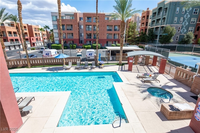 view of pool with a community hot tub and a patio area