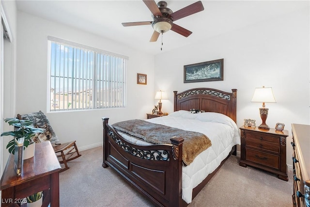 bedroom with ceiling fan, carpet, and baseboards