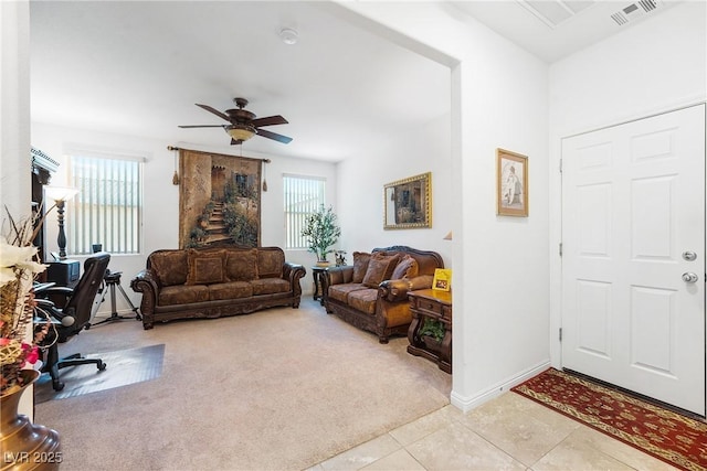 interior space with light tile patterned floors, a wealth of natural light, visible vents, and light colored carpet