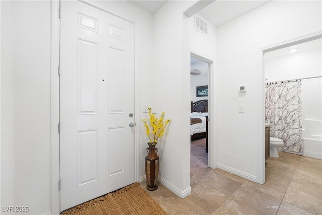 interior space featuring baseboards and visible vents