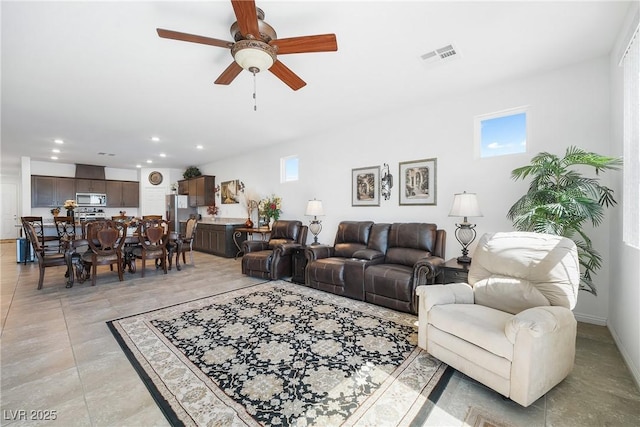 living area with recessed lighting, visible vents, and a ceiling fan