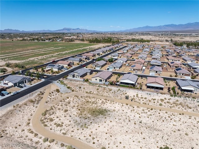 drone / aerial view featuring a residential view and a mountain view