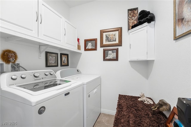 laundry area featuring separate washer and dryer, light tile patterned flooring, cabinet space, and baseboards