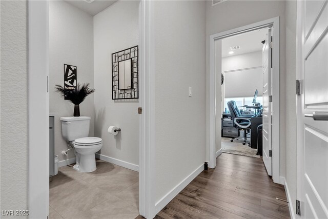 bathroom featuring hardwood / wood-style floors and toilet