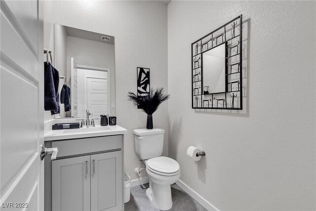 bathroom with tile patterned floors, vanity, and toilet