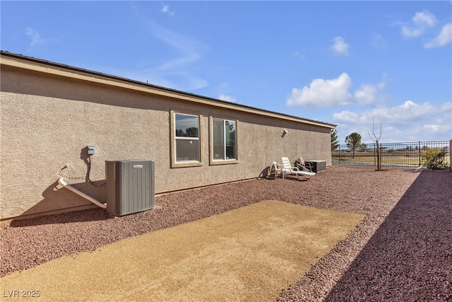 exterior space with cooling unit and a patio