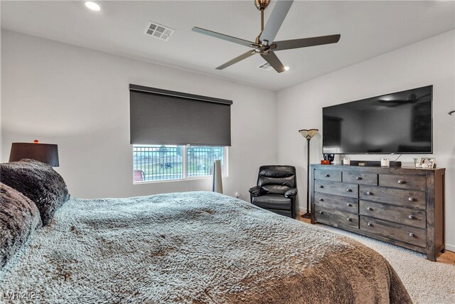 bedroom with light carpet and ceiling fan