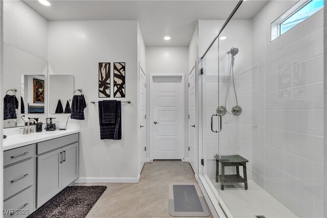 bathroom with vanity, a shower with shower door, and tile patterned floors