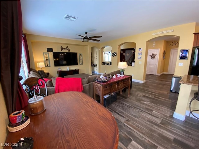 dining area with dark wood-type flooring and ceiling fan