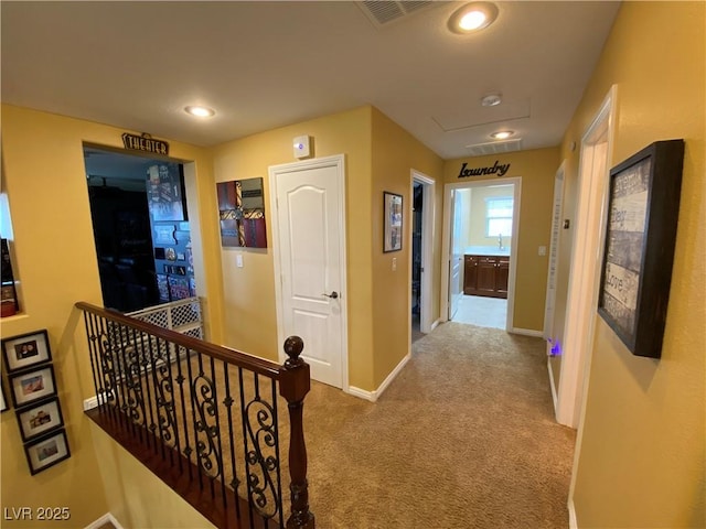 hall featuring light carpet and sink