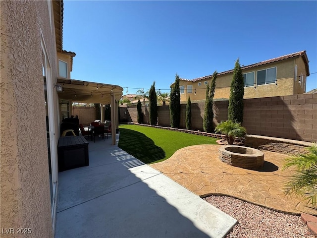 view of yard with a patio area and an outdoor fire pit