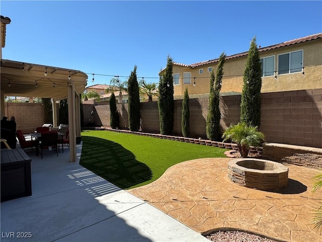 view of yard featuring an outdoor fire pit and a patio area