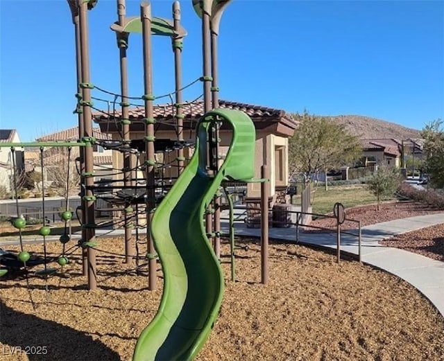 community jungle gym featuring a mountain view