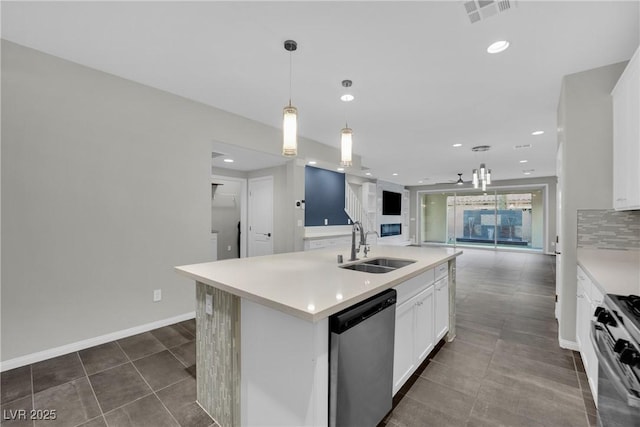 kitchen with open floor plan, gas range, dishwasher, decorative backsplash, and a sink